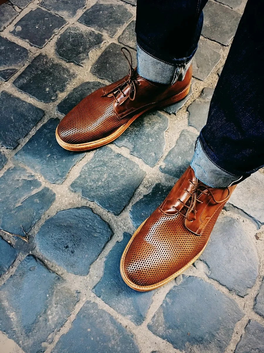 Brown woven leather shoes on cobblestones