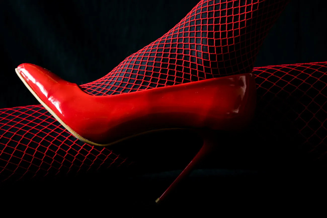Red patent stiletto with red fishnet tights