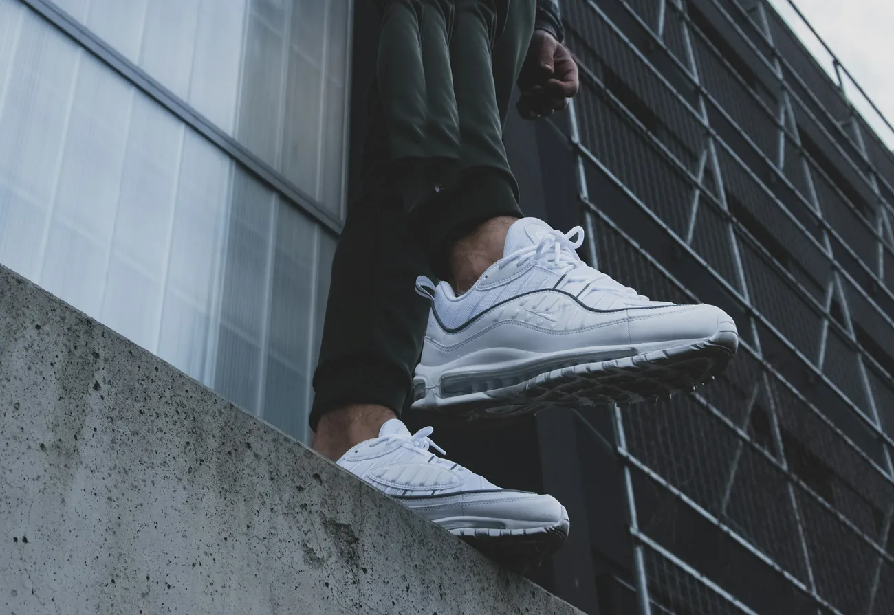 White running sneakers on a concrete ledge